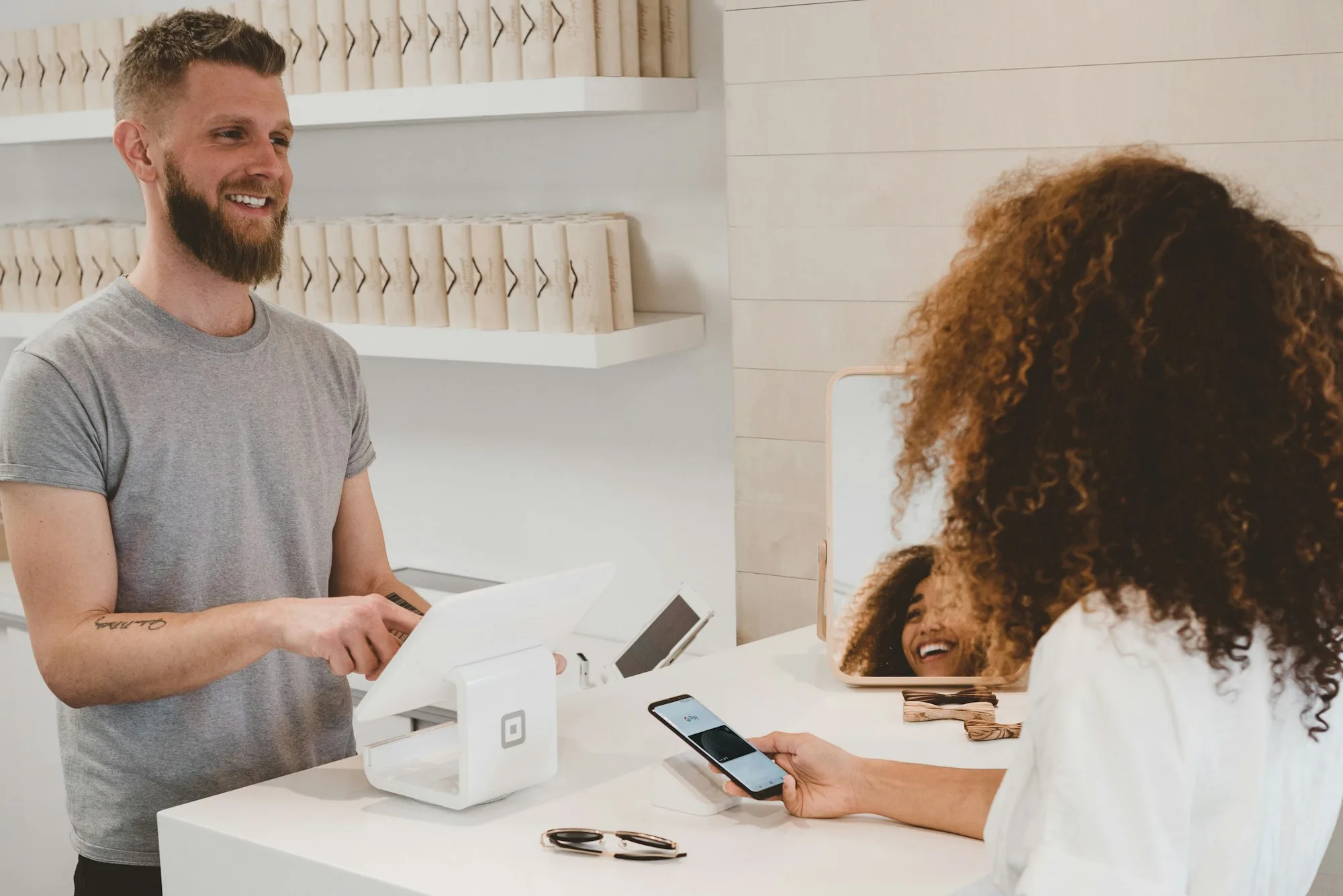 Customer completing a payment at a retail counter