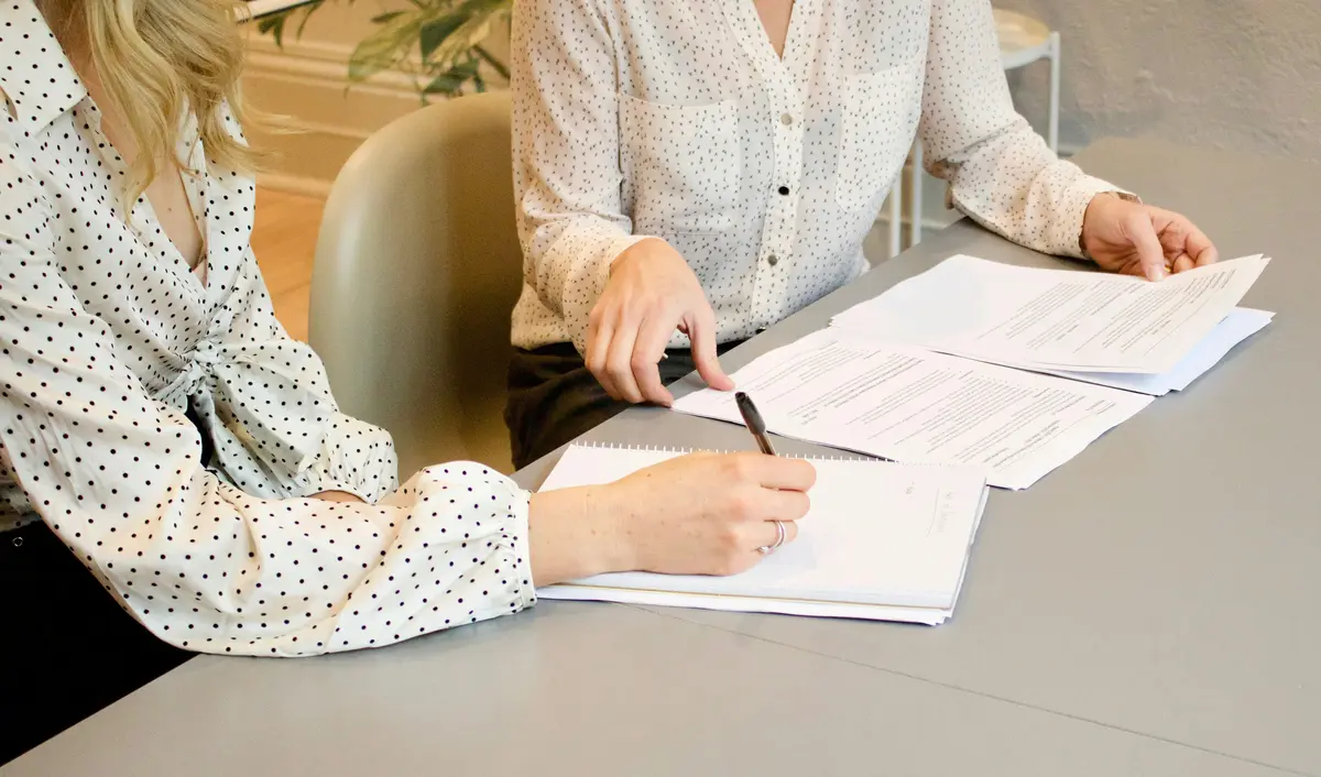 Legal professionals reviewing documents at a desk