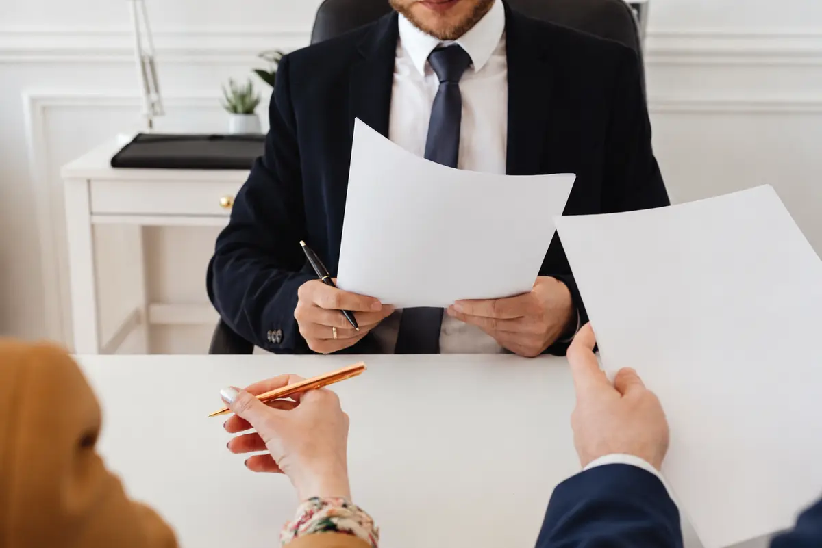 Legal professionals reviewing documents at a desk